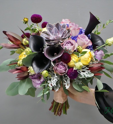 Bridal bouquet with black calla lilies, yellow peony-style roses, blue hydrangea, purple roses, and succulents photo 394x433